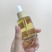 Eco friendly cosmetic skincare packaging container round clear bamboo glass dropper bottle for essential oils